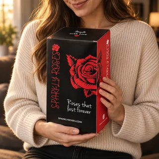 A woman holding a tall Sparkly Roses gift box against her chest