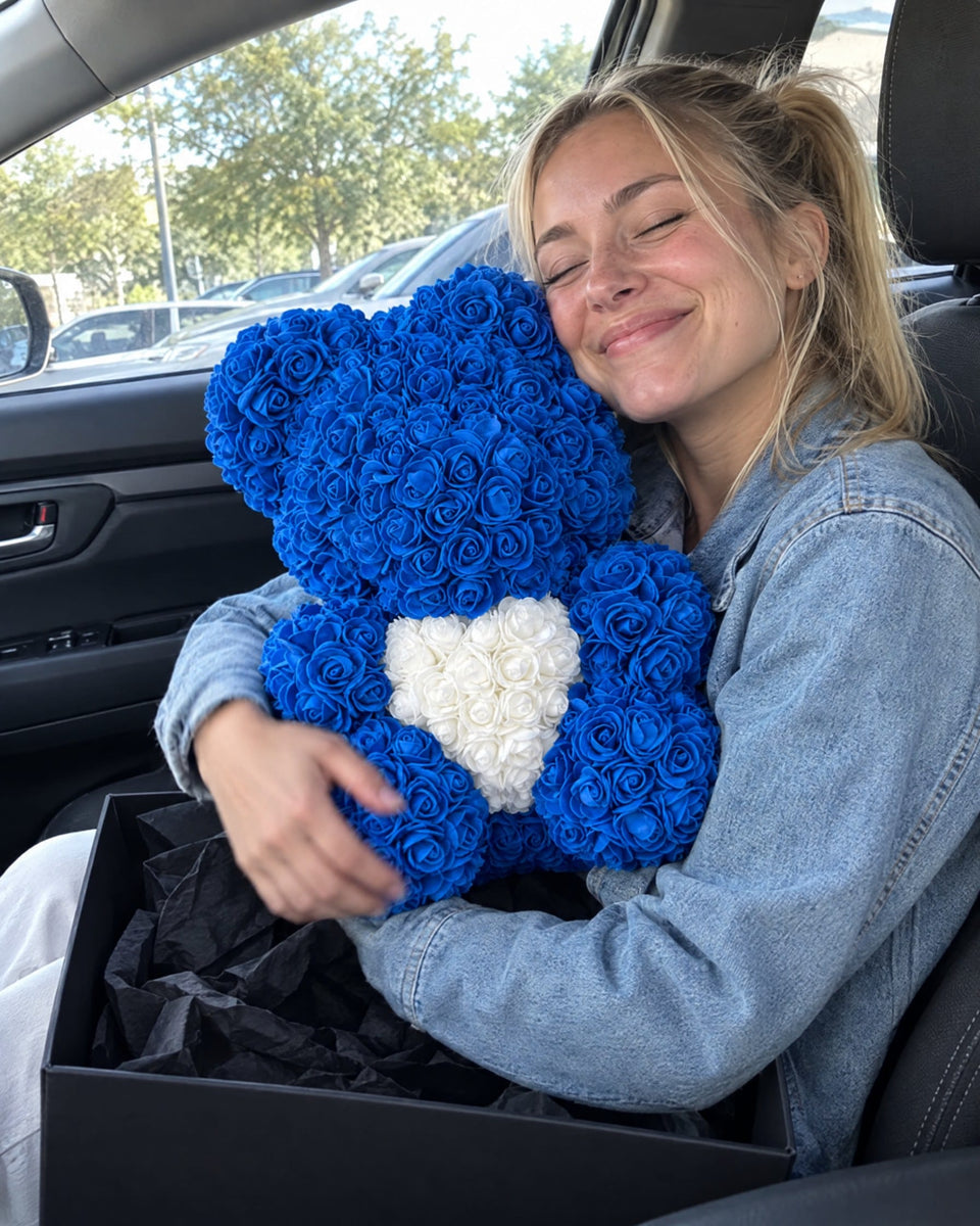 Woman hugging a blue Rose Bear