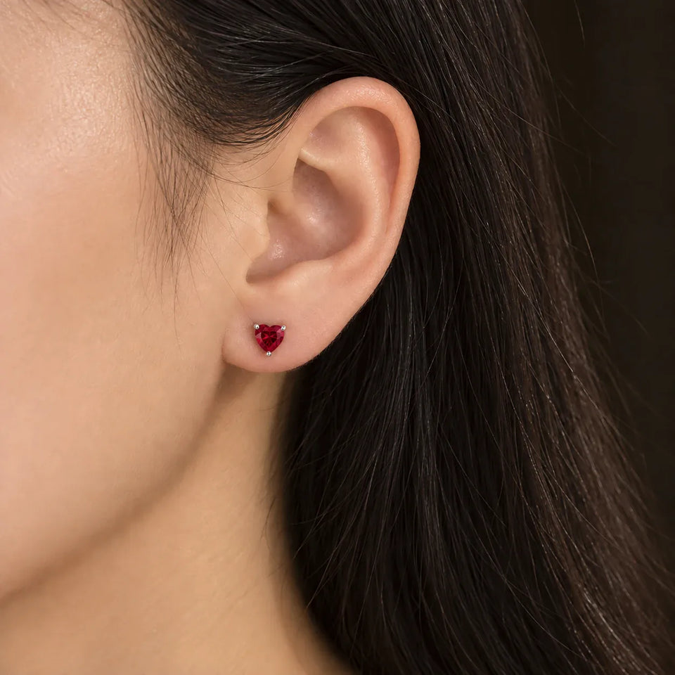 Red heart stud worn on an ear