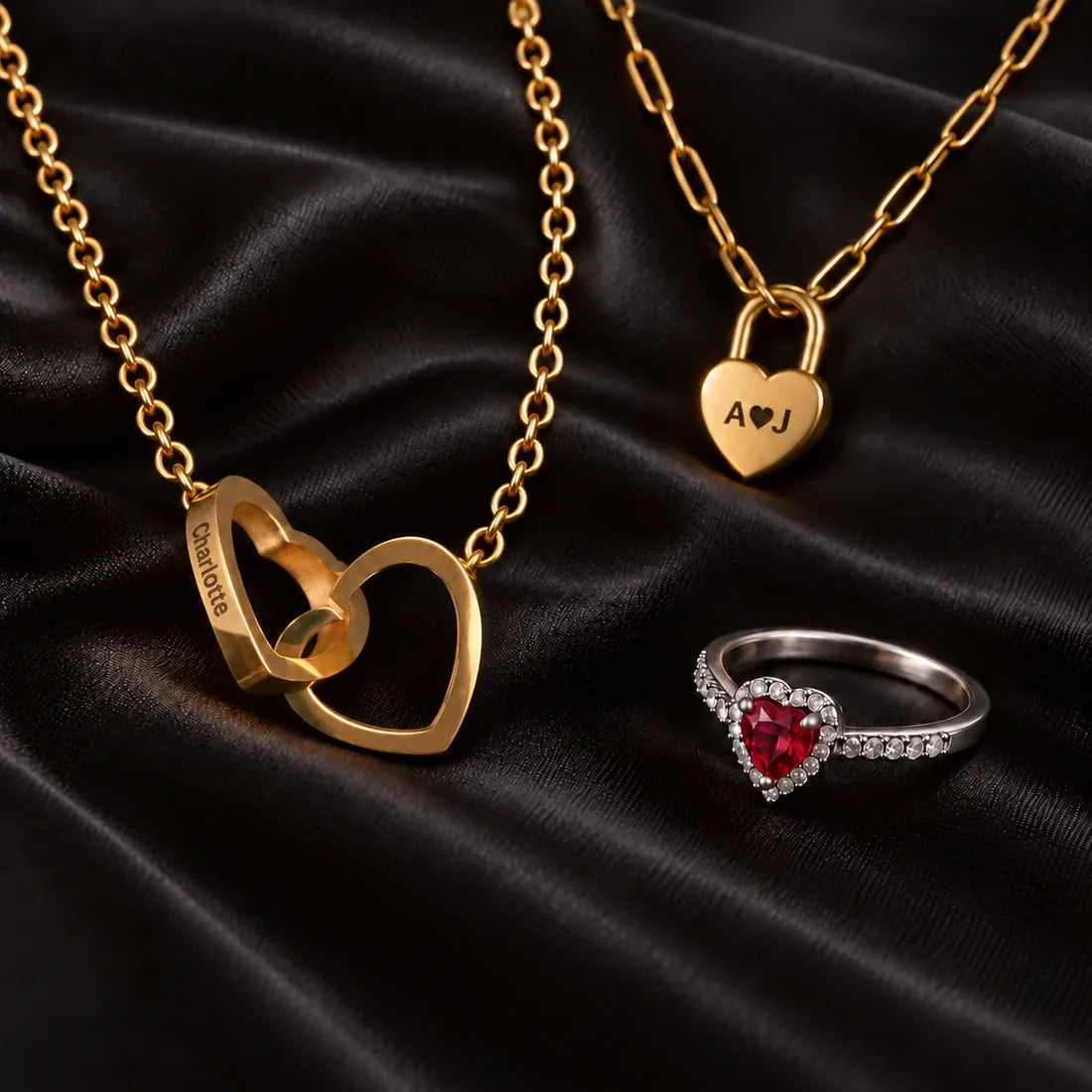 Engraved Heart Lock and Linked Hearts necklaces with the Promise Ring on black velvet