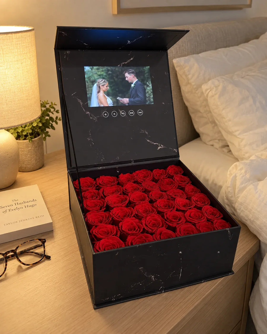 The rose movie box beside a bed with a wedding memory on screen