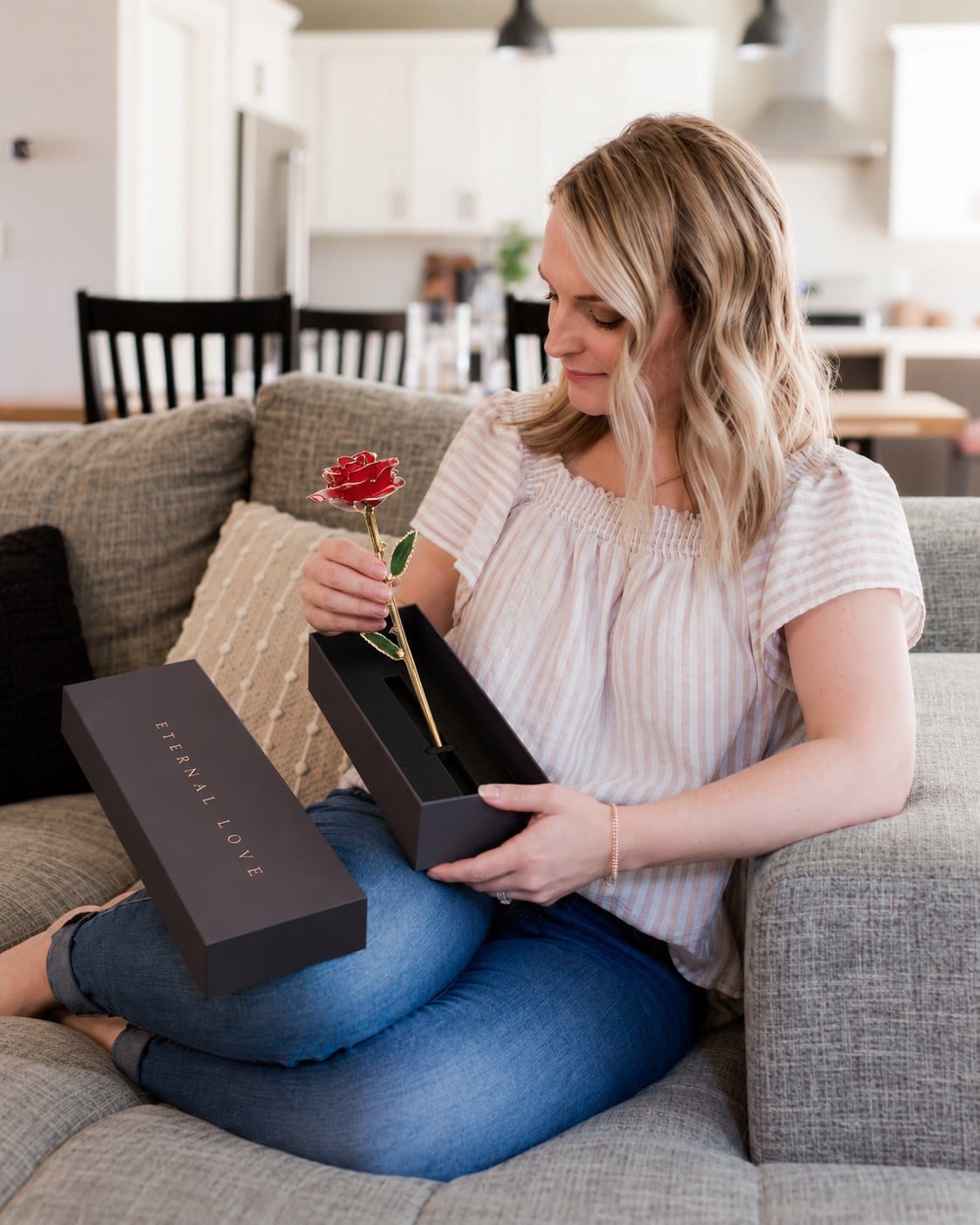 She lifts the red gold rose out of its Eternal Love gift box