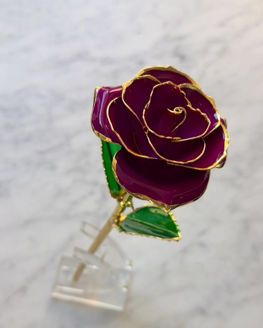 A gold stem with lacquered green leaves.