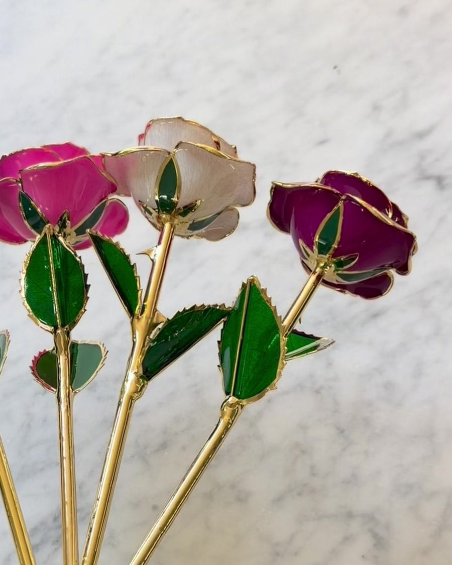 Three gold roses held together