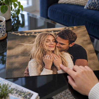 A hand placing the last piece of a photo puzzle